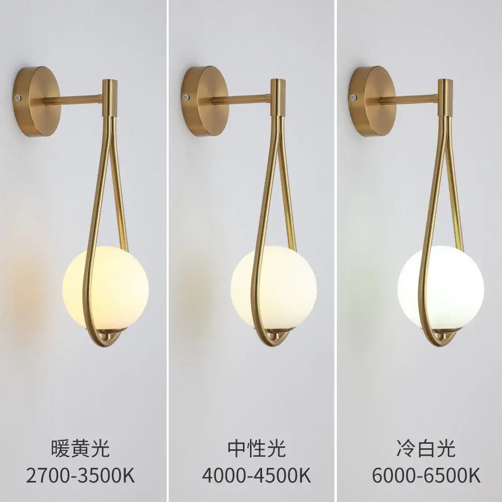 Modern black and gold wall lamp with decorbites glass ball led frosted globe emitting warm to cool light for bedroom sconce