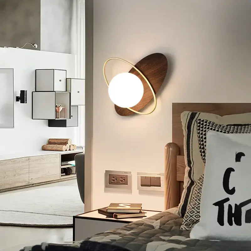 Modern black and gold glass ball led wall lamp with warm glow frosted glass bulb on dark wood disc decorbites glass ball