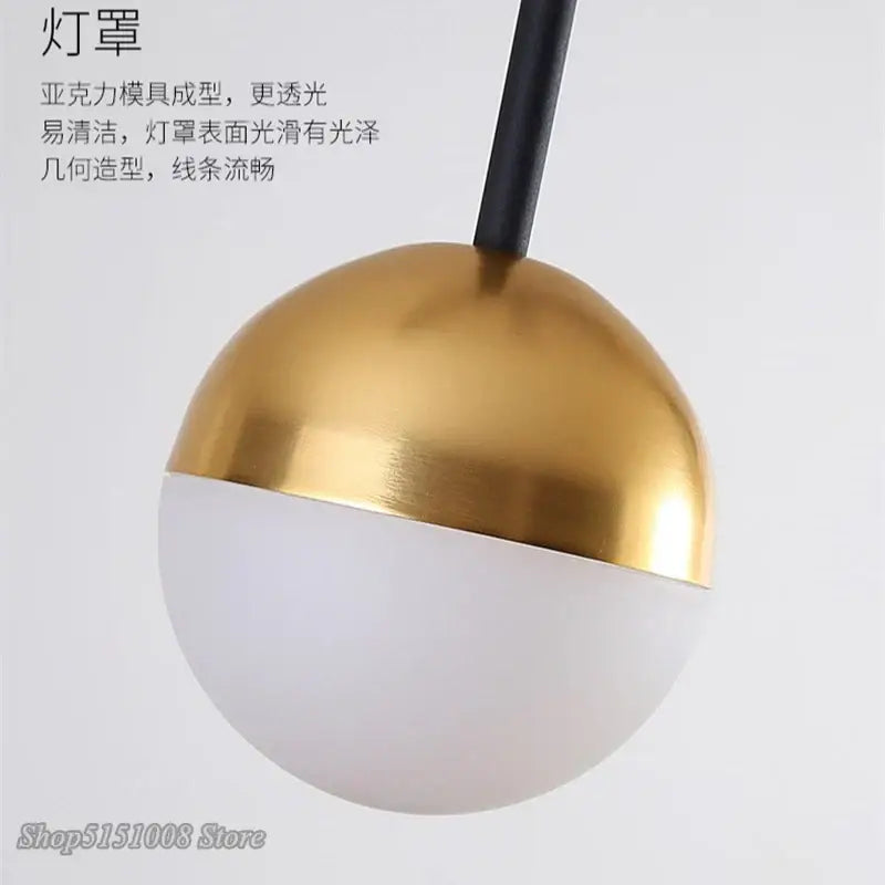 Modern black and gold glass ball pendant lamp with gold-accented spherical frosted white glass for dining room decorbites glass ball pendant