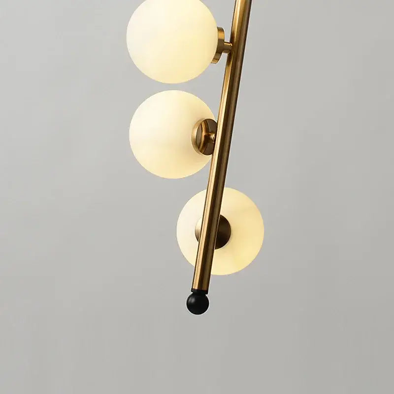 Modern black and gold decorbites glass ball pendant lights with brass finish and frosted globes for dining room lighting