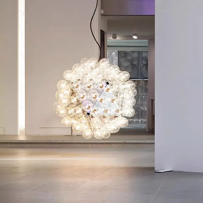 Modern black and gold glass dandelion led chandelier featuring clear glass bulbs illuminated with warm white light