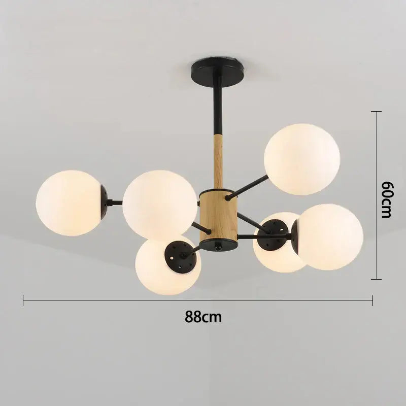 Modern pendant light with six frosted glass globes black metal arms and wooden cylinder decorbites black gold glass design