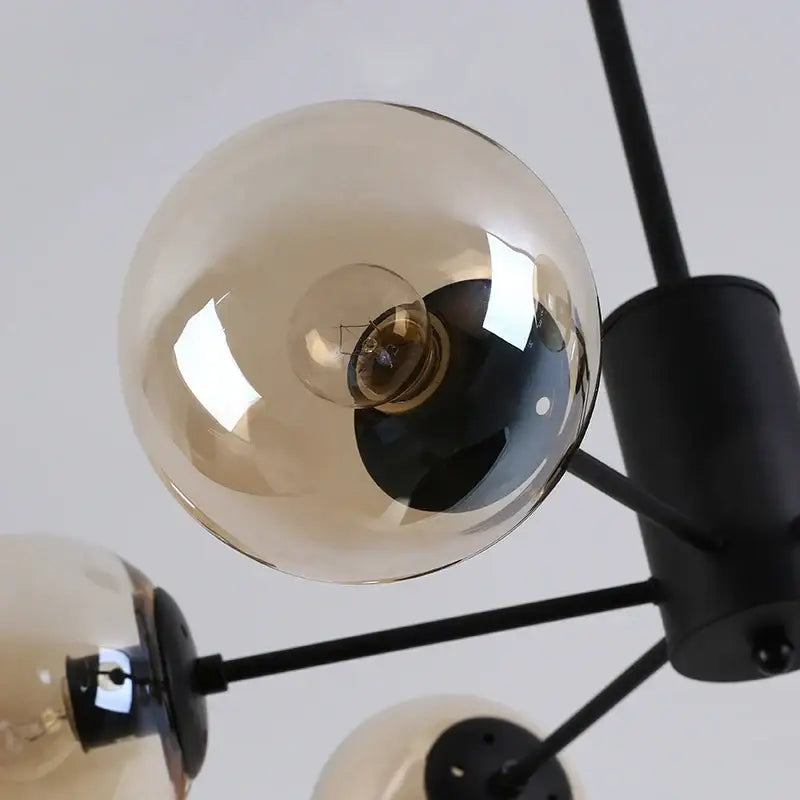 Modern black gold glass pendant light with smoked glass globe shades and black metal arms for living room decorbites black gold