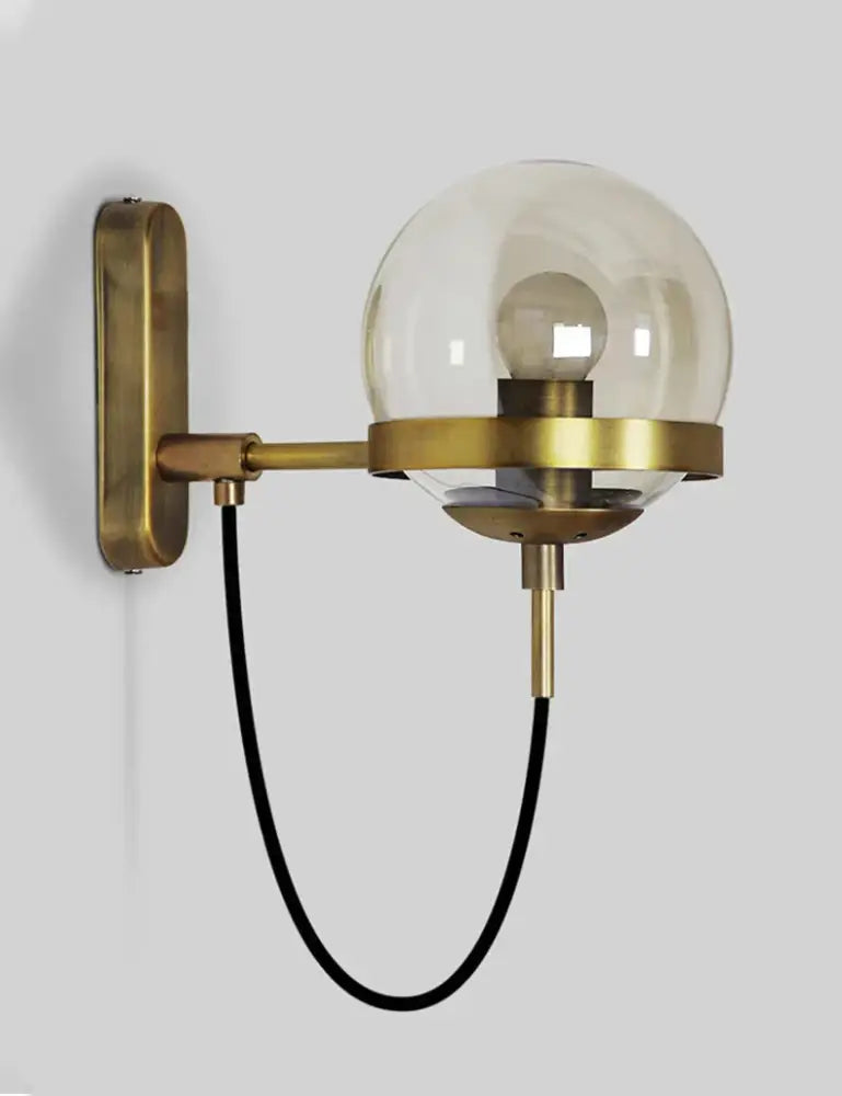 Modern black and gold glass globe wall sconce featuring a brass finish and black fabric cord for bedroom lighting wall sconce lamps