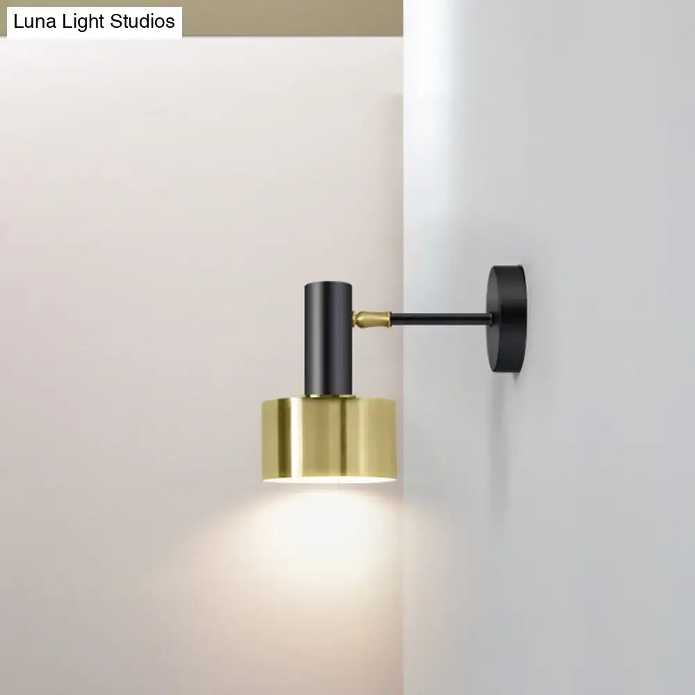 Modern black and gold grenade shaped wall lamp with sleek brass finish and adjustable arm for directional bedroom reading light