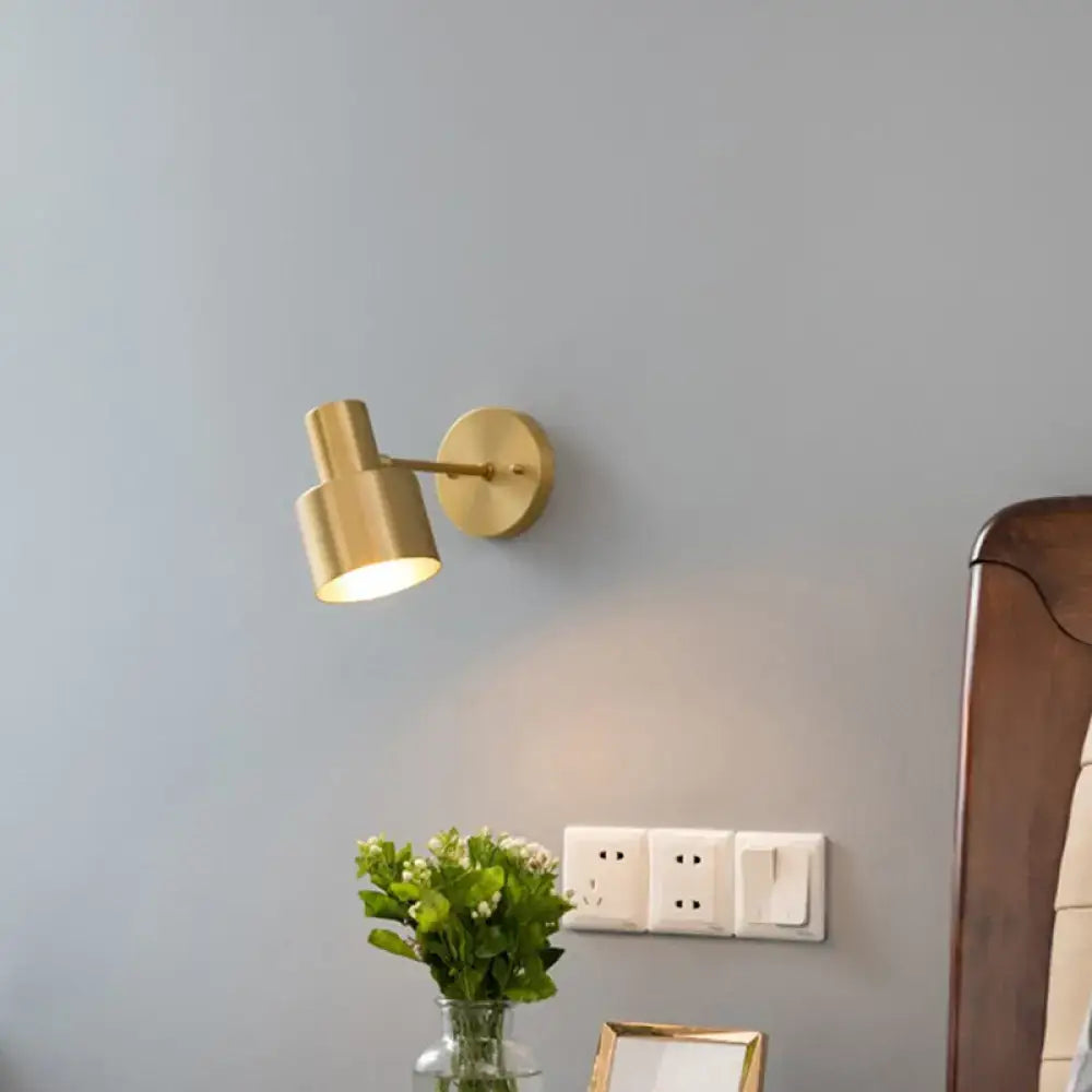 Modern black and gold grenade shaped wall lamp with gold-toned cylindrical reading light and adjustable arm for bedroom use