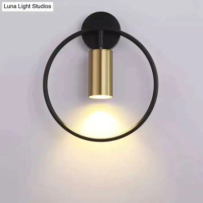 Modern black and gold irwin wall lamp with a sleek minimalist circular design for bedroom lighting