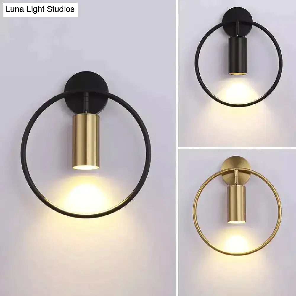 Modern black and gold irwin wall lamp featuring a sleek cylindrical light fixture for bedroom wall lamp use