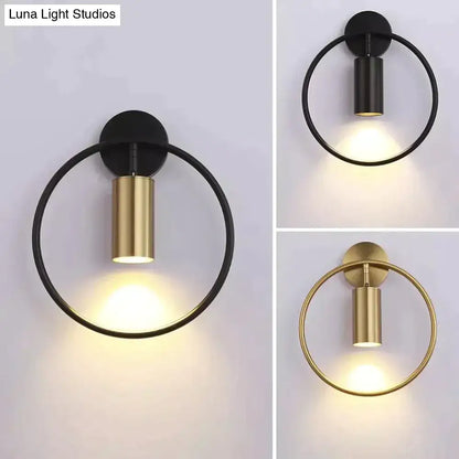 Modern black and gold irwin wall lamp featuring a sleek cylindrical light fixture for bedroom wall lamp use