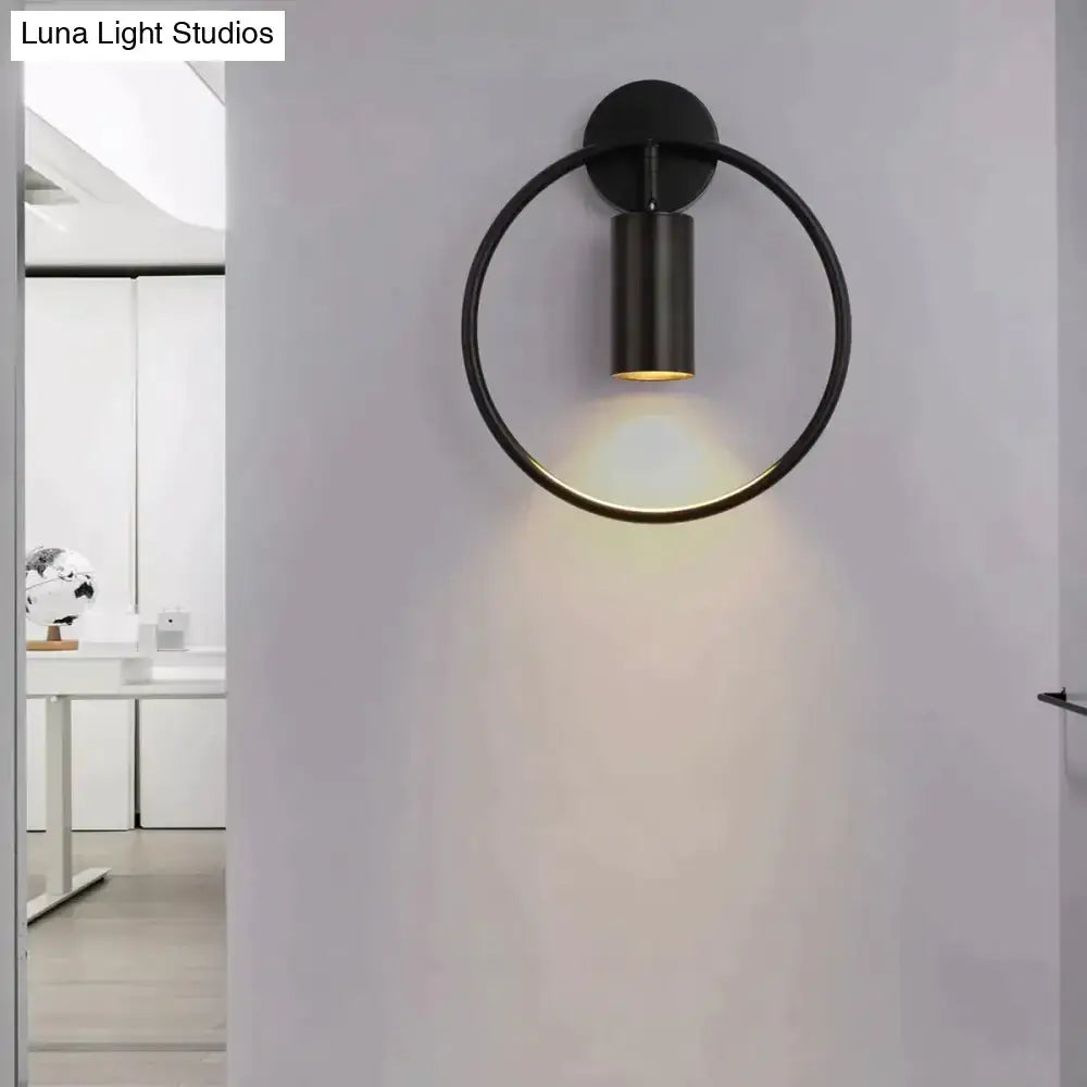 Modern black and gold irwin wall lamp with sleek circular design and warm ambient lighting for bedroom sconce use