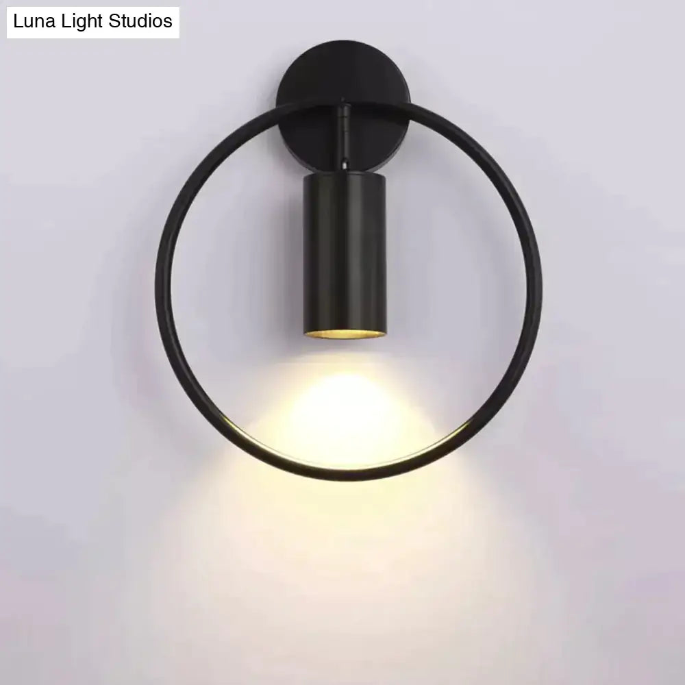 Modern black and gold irwin wall lamp with sleek circular design and warm ambient lighting for bedroom sconce use