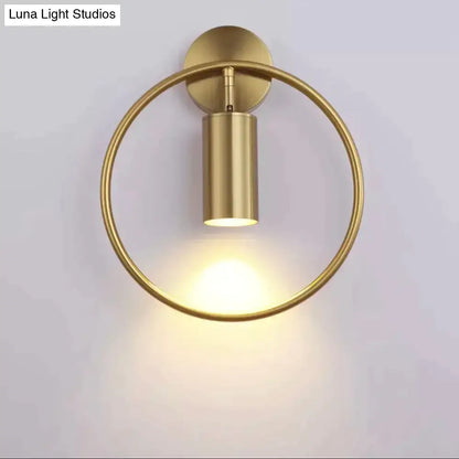Gold-finished modern irwin wall lamp with circular ring and cylindrical light fixture for bedroom sconce lighting