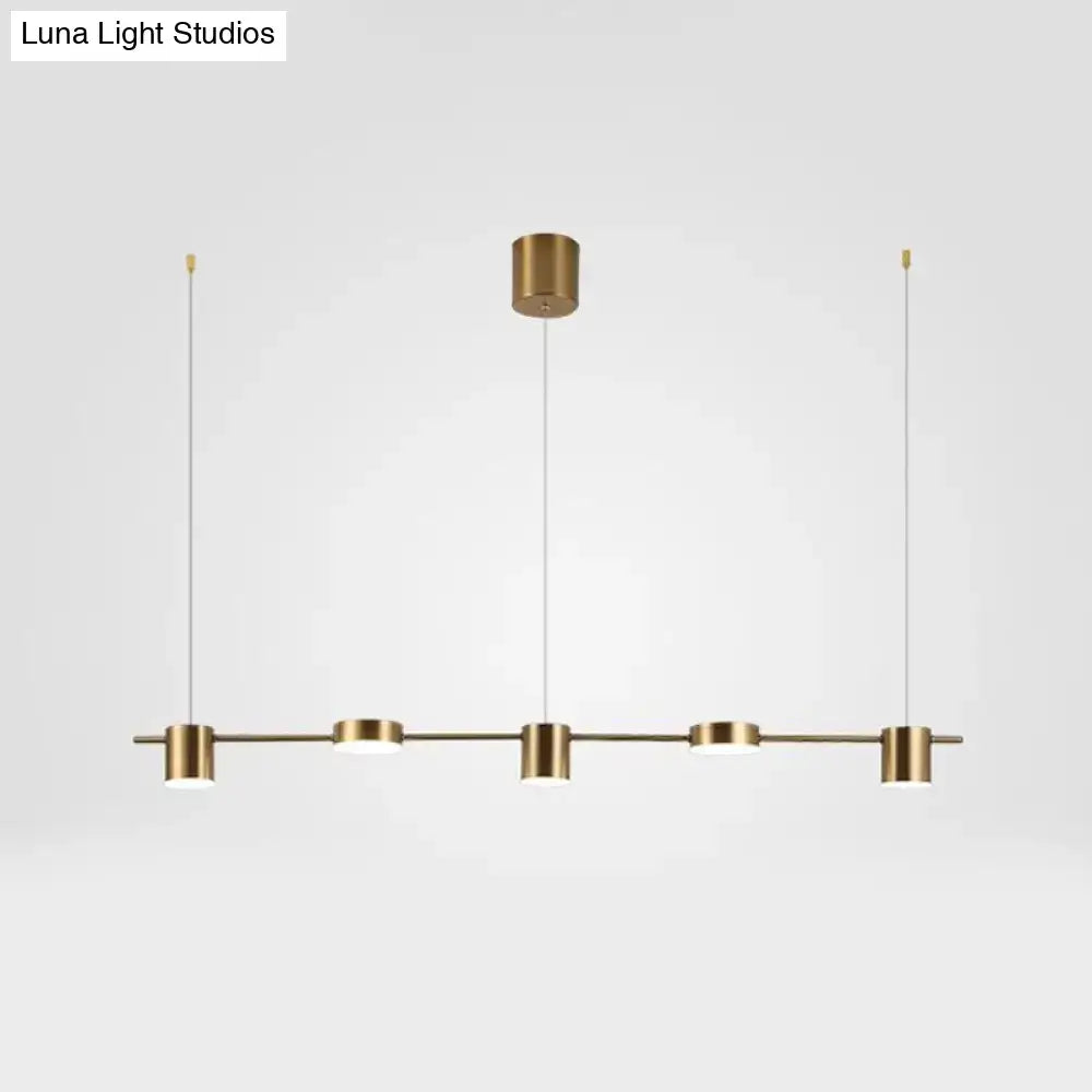 Modern black gold ceiling light fixture with brass finish and four cylindrical pendant lights for kitchen island lighting