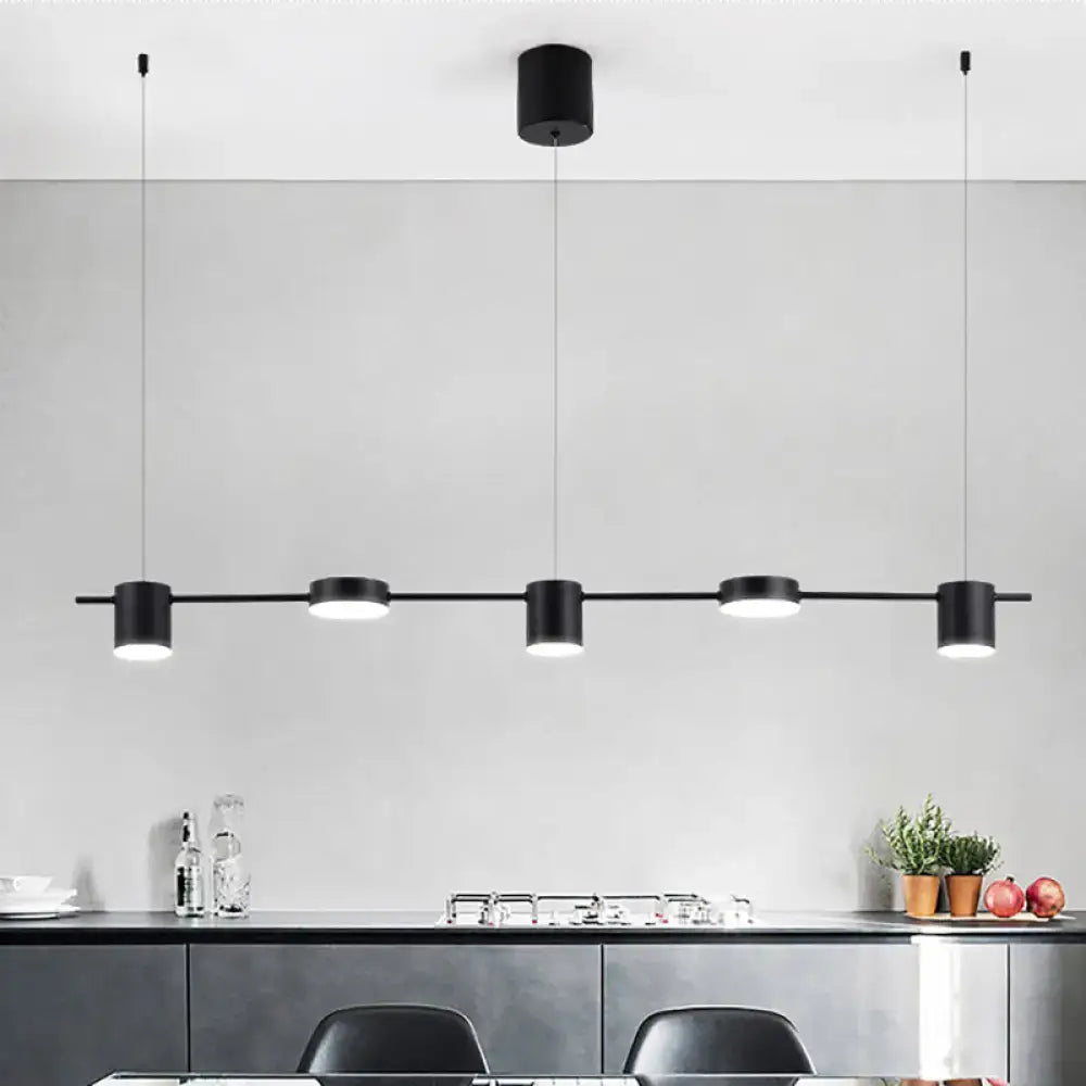 Modern black gold ceiling light fixture with four cylindrical pendant lights for kitchen island illumination