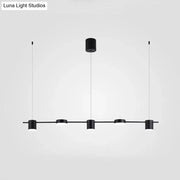 Modern black and gold ceiling light fixture featuring four minimalist cylindrical pendants for kitchen island lighting