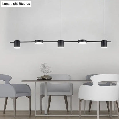 Modern black and gold cylindrical pendant light fixture ceiling light fixture in minimalist dining room setting