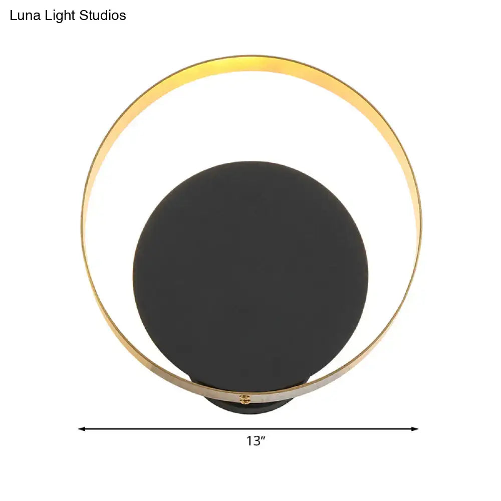 Modern black and gold led bedroom sconce with a sleek matte black disc and gold ring 12 inch fixture with pull chain