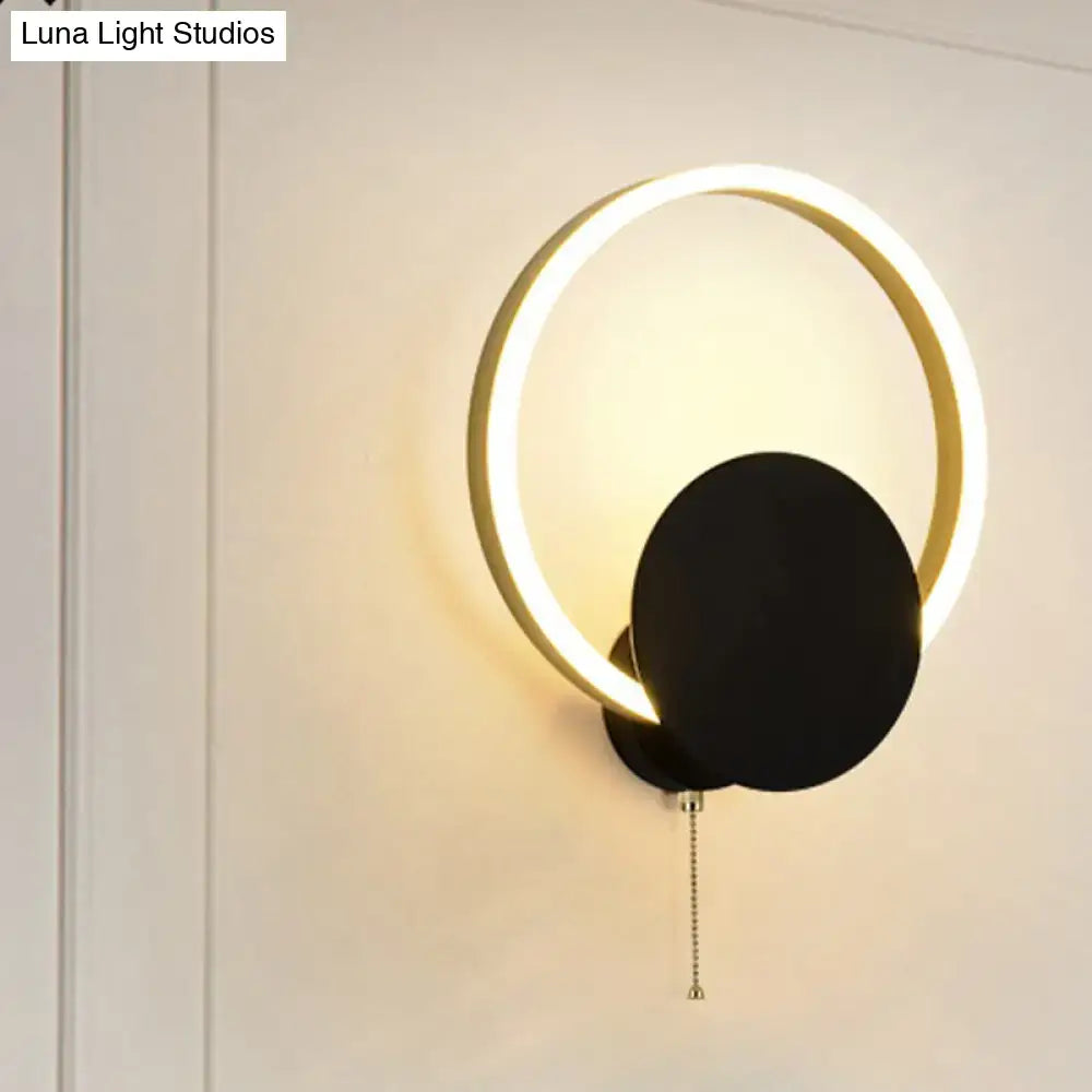 Modern black and gold led bedroom sconce with pull chain featuring a minimalist 12 inch fixture with glowing gold ring