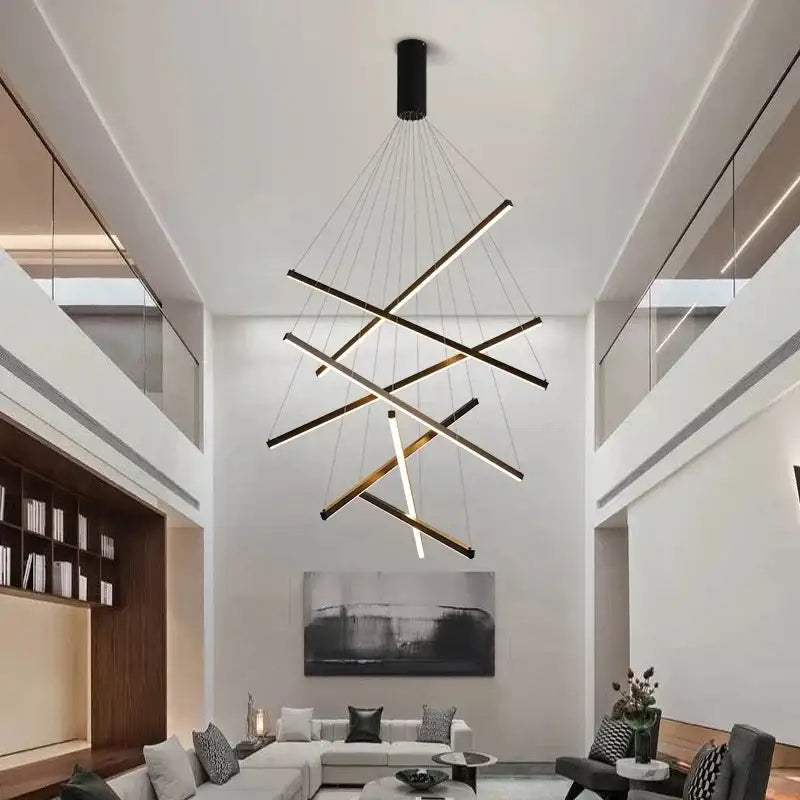 Modern black and gold led chandelier with geometric intersecting rods suspended by thin cables for staircase decorbites black stair lighting