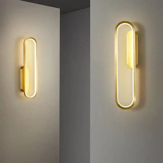 Modern black and gold led indoor wall light with gold-finished oval frame providing warm ambient lighting decorbites black