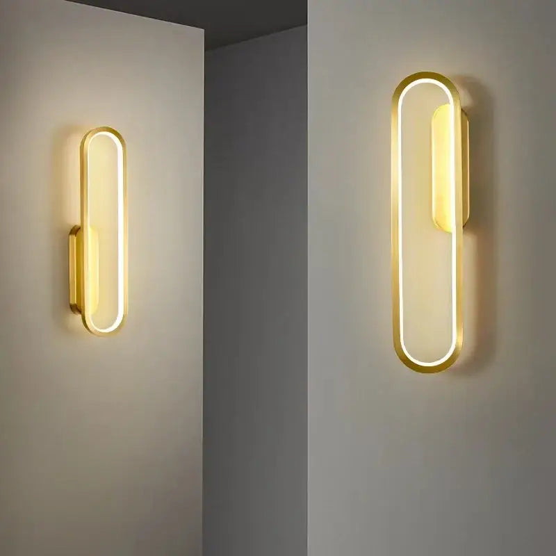 Modern black and gold led indoor wall light with gold-finished oval frame providing warm ambient lighting decorbites black