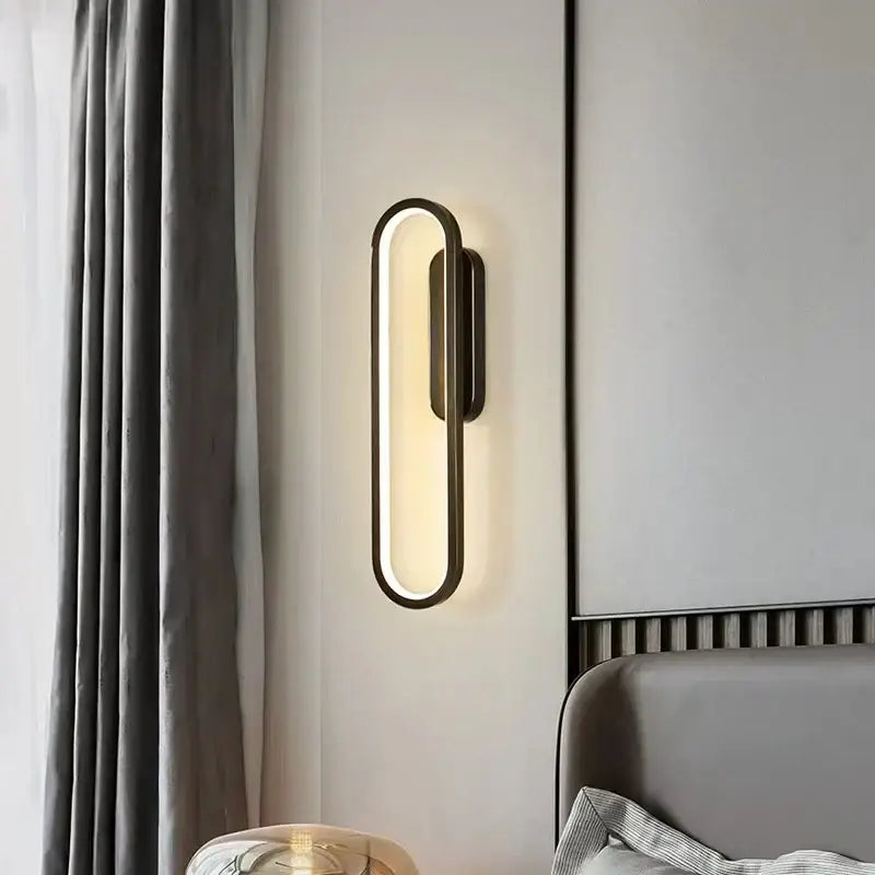 Modern black and gold led indoor wall light by decorbites with sleek oval design emitting warm ambient light for living room decor