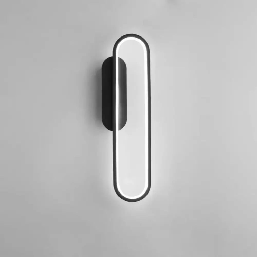 Modern black and gold led indoor wall light with sleek elongated oval design and glowing edge led strip for living room decorbites black