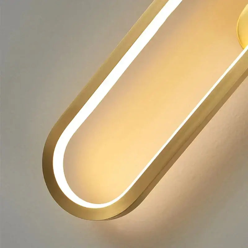 Modern black and gold led indoor wall light with a gold-toned curved design and warm ambient lighting decorbites black
