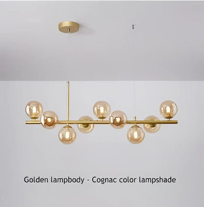 Modern black led pendant chandelier featuring spherical cognac glass lampshades on a polished brass frame for living room
