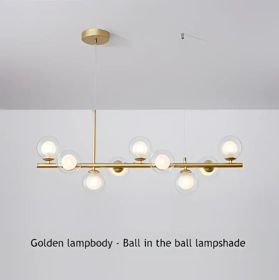 Modern black and gold led pendant chandelier with sleek polished brass bar and spherical glass lampshades for living room