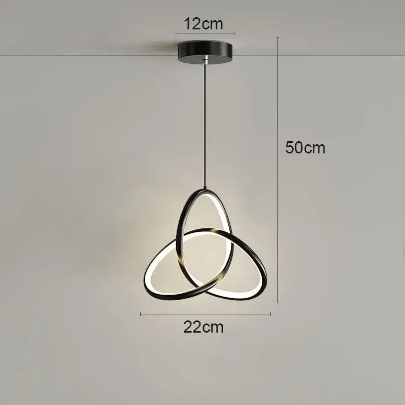 Modern black and gold led pendant light with three interlocking oval rings for dining room illumination