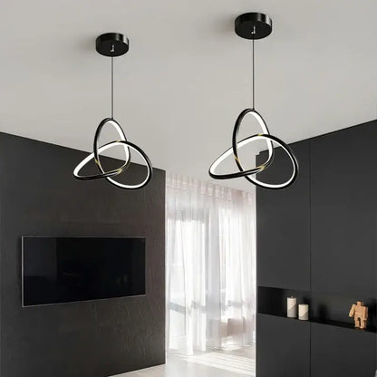 Modern black and gold led pendant light with interlocking black and white rings for dining room lighting