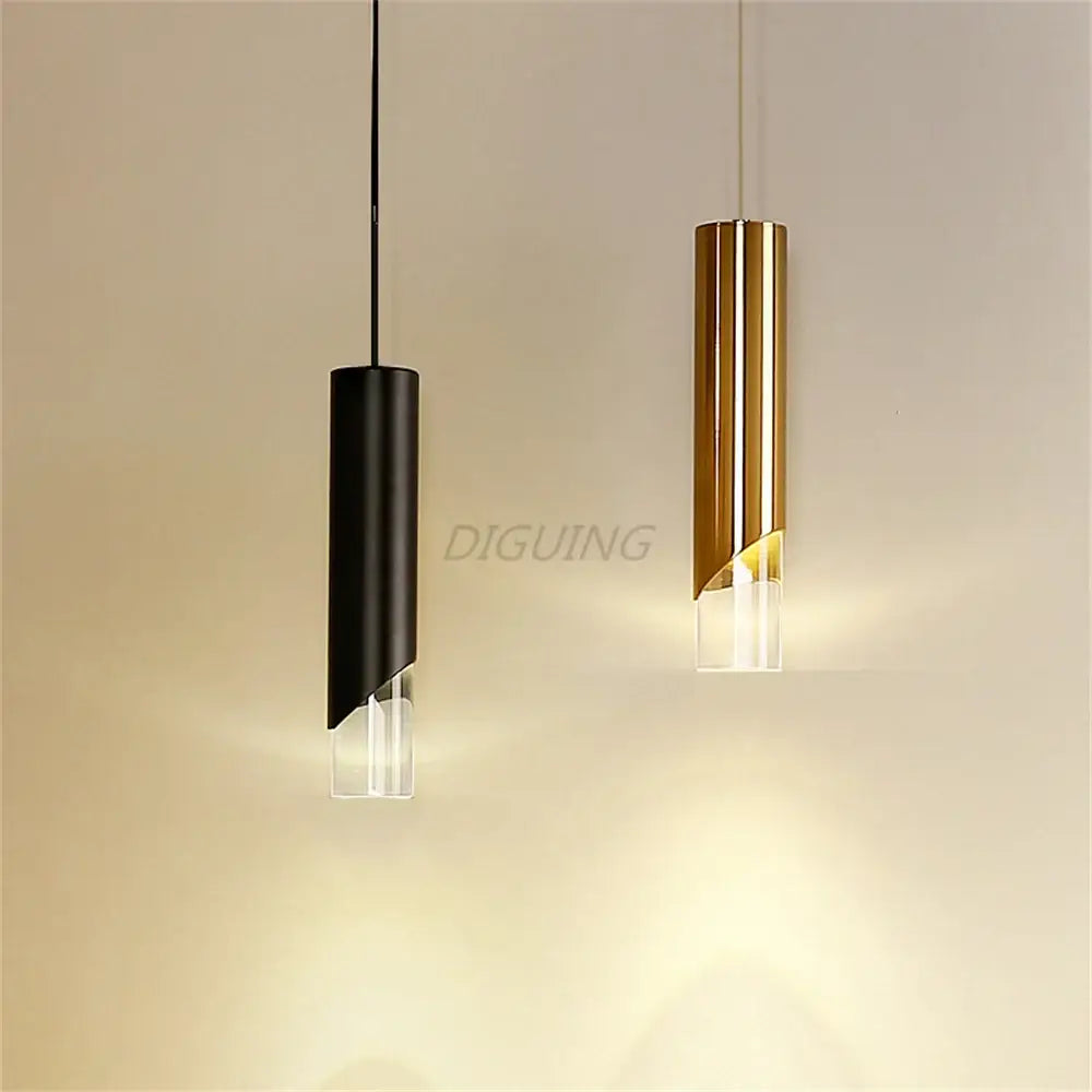 Two modern black and gold led pendant lights with clear glass bases made of high-quality die-cast aluminum emitting warm light