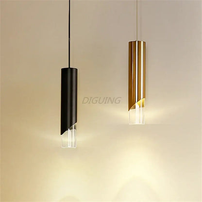 Two modern black and gold led pendant lights with clear glass bases made of high-quality die-cast aluminum emitting warm light