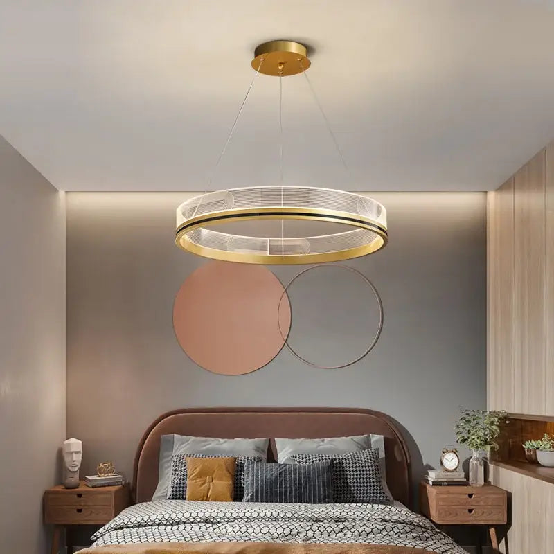 Modern black gold led pendant light featuring a circular gold-toned metal frame with clear acrylic rings for dining room use
