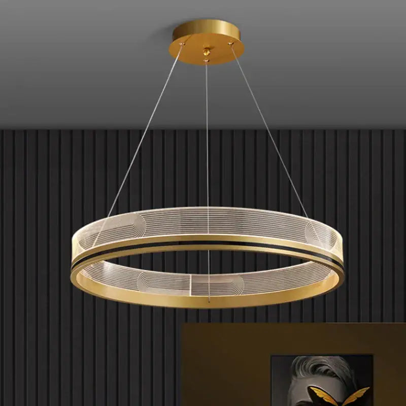 Modern black gold led pendant light with gold-toned circular mesh design and black accent bands for dining room use