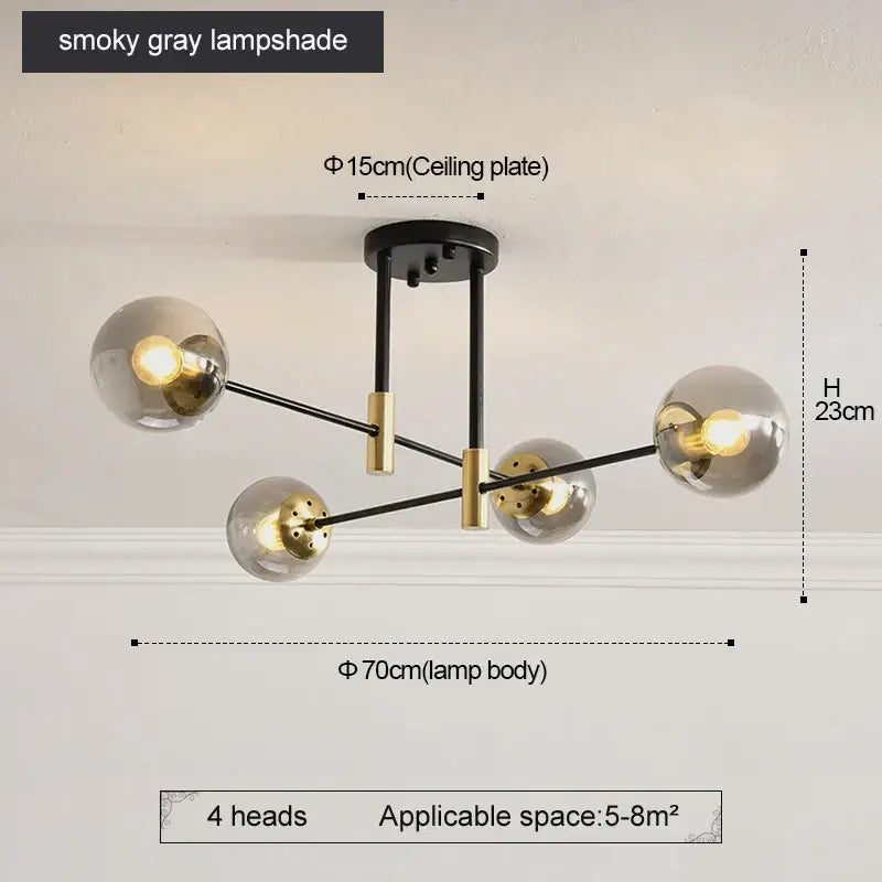 Modern black and gold led round ball chandelier with four smoky gray glass shades and brass toned metal arms for dining room