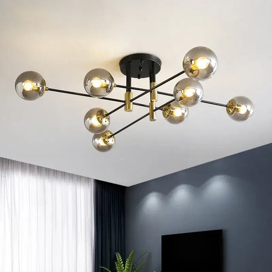 Modern black and gold led round ball chandelier with spherical glass bulbs on metal arms for dining room lighting