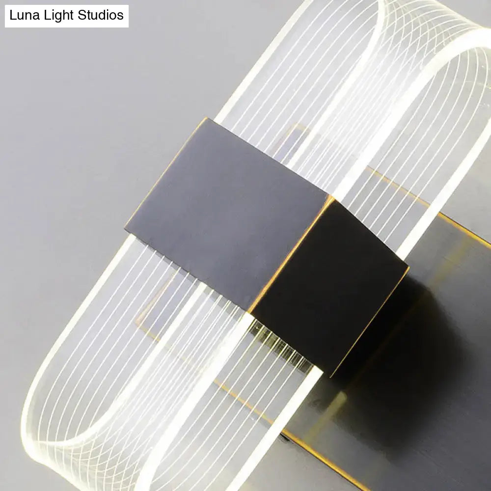 Modern black and gold LED sconce light with a curved translucent acrylic body and matte black accents for bedroom wall mount