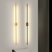 Two modern minimalist wall lamps with black and gold finishes featuring decorbites led strip vertical rods emitting warm light