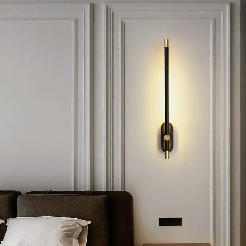 Gold-toned modern black and gold led strip wall lamp with circular bases illuminates a minimalist bedroom decorbites led strip wall