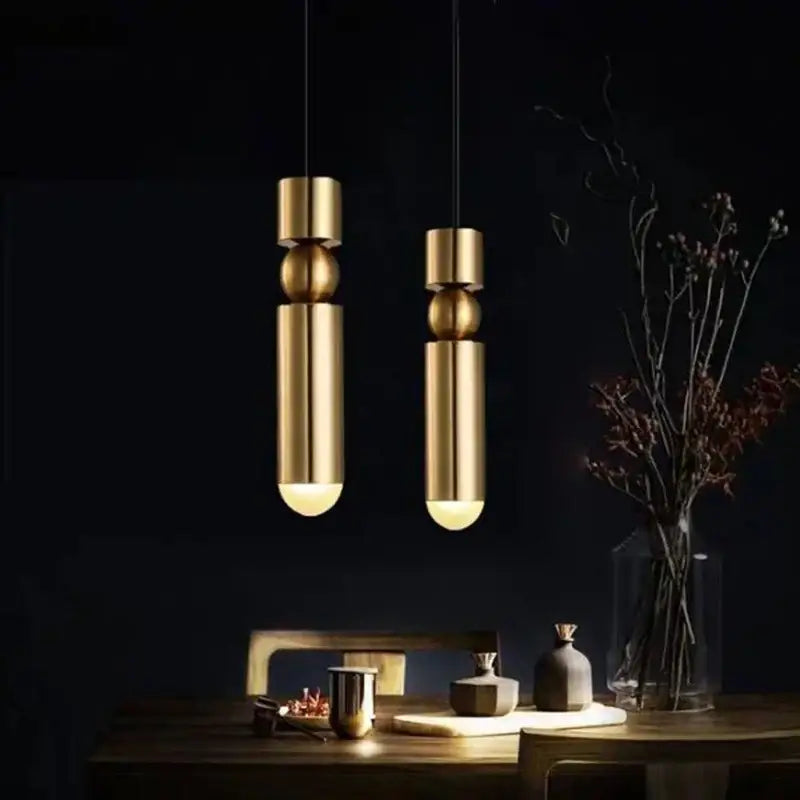 Modern black gold led tube pendant lamp featuring two brushed gold cylindrical lights with spherical accents for kitchen decorbites black gold