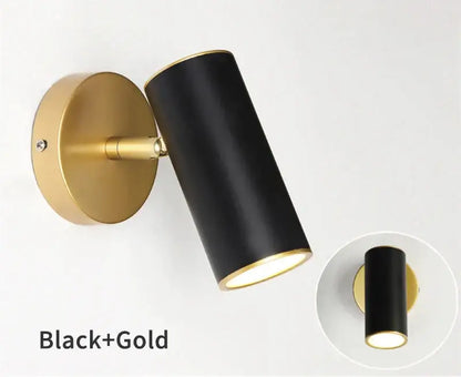 Modern black and gold led wall lamp with cylindrical sconce and gold-toned circular base for bedroom lighting