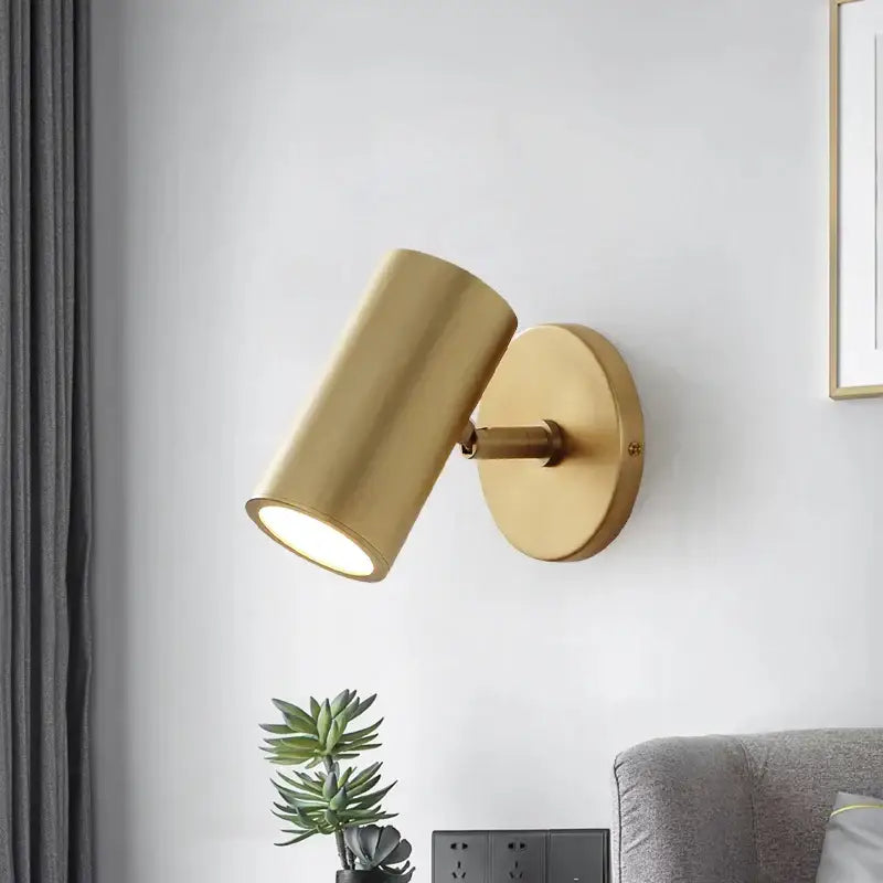 Modern black and gold led wall lamp featuring a gold-finished cylindrical spotlight with adjustable matte metallic head