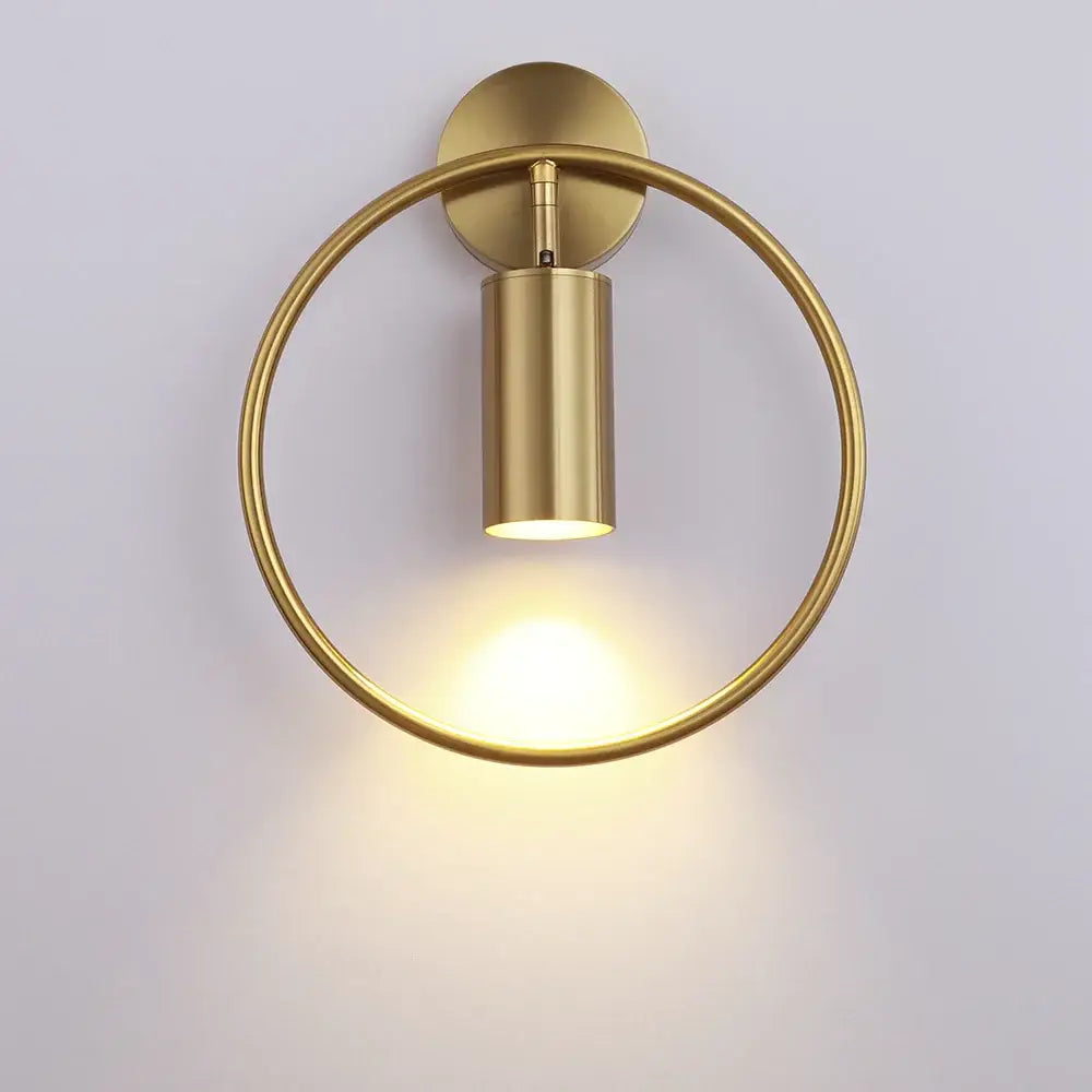 Modern black and gold led wall lamp with brass-finished circular sconce and cylindrical light fixture for living room or bedroom