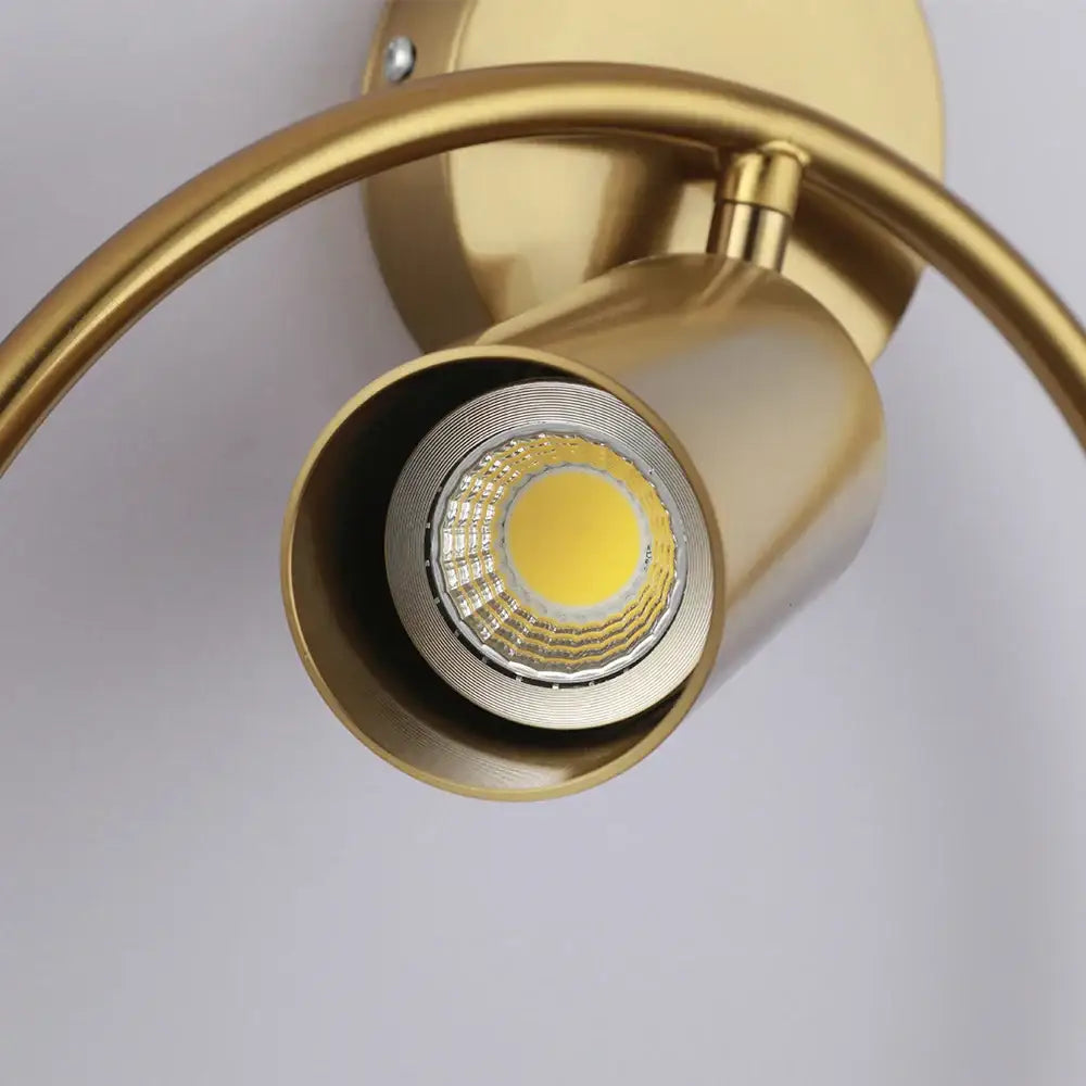 Modern black and gold led wall lamp with gold-finished curved arm and adjustable head for living room and bedroom use