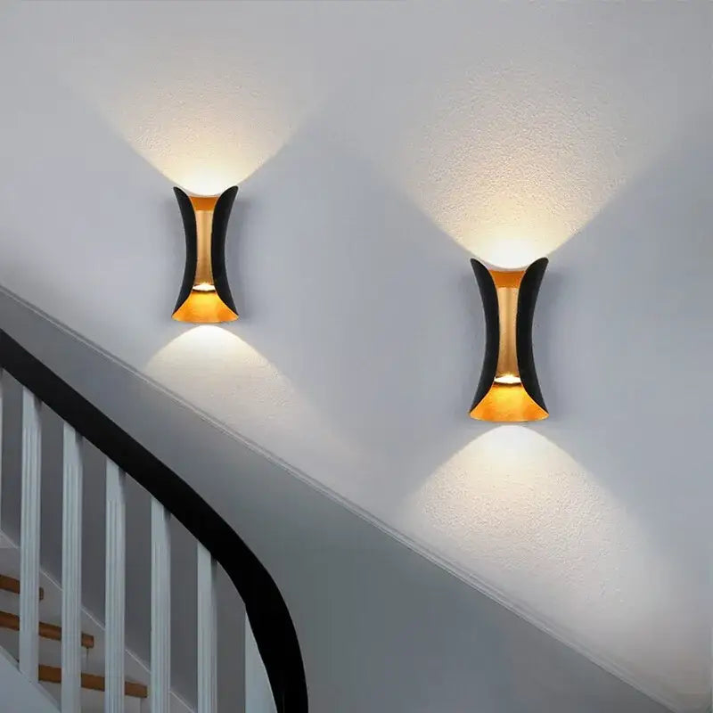Modern black and gold led wall lamp with sleek curved design casting warm light for living room decorbites led wall lamp
