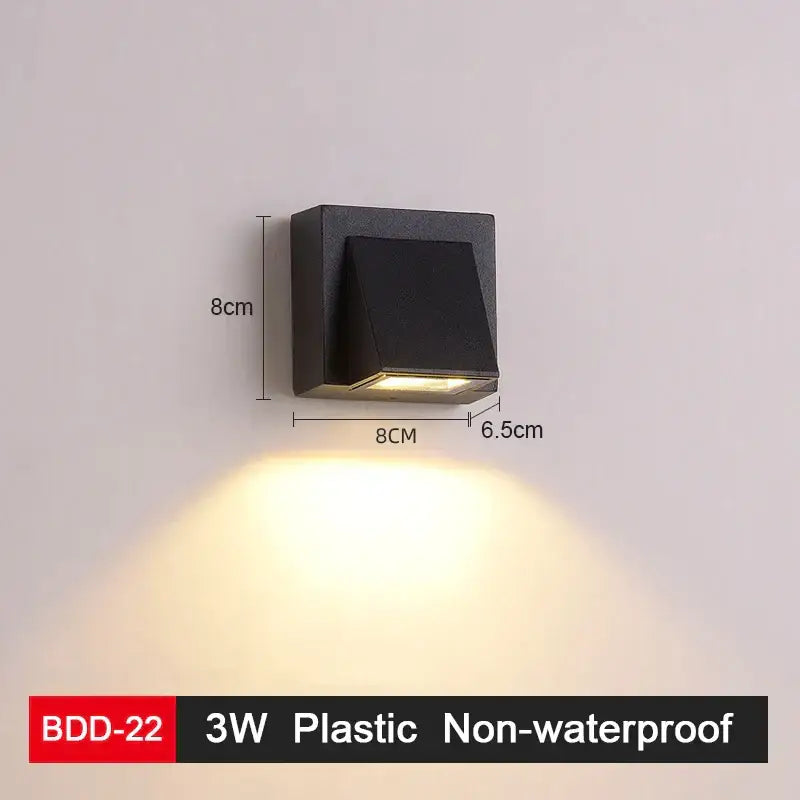 Modern black plastic wall lamp with gold accents and an angled diffuser for sleek living room decorbites led wall lighting