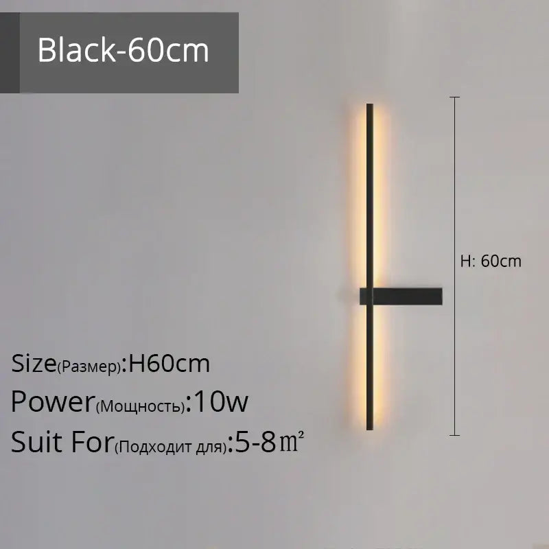 Modern black and gold led wall lamp with a sleek vertical bar emits warm ambient light for living room use