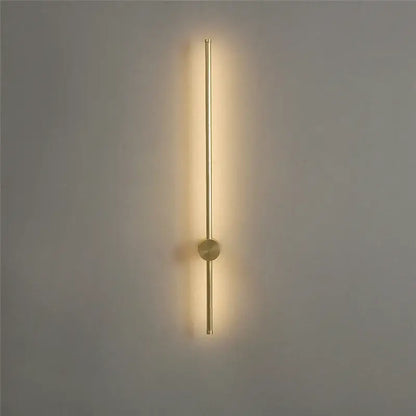 Gold-toned minimalist led wall lamps by decorbites with sleek vertical rod and warm ambient light for modern living room decor